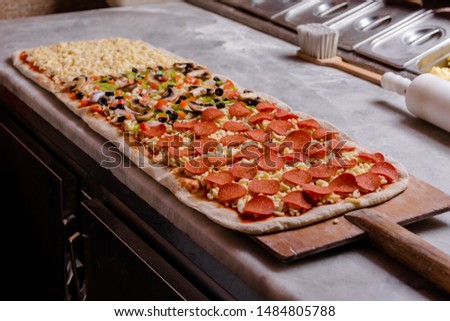 One Meter Long Pizza Directly from the Traditional Oven Served Royalty-Free Stock Photo #1484805788