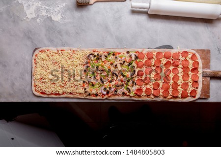 One Meter Long Pizza Directly from the Traditional Oven Served Royalty-Free Stock Photo #1484805803