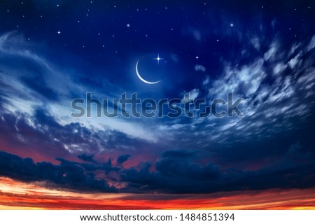 Beautiful dark fluffy cloudy sky with sun rays . Crescent moon with beautiful sunset background . Generous Ramadan . New moon. Prayer time. 