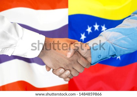 Business handshake on the background of two flags. Men handshake on the background of the Thailand and Venezuela flag. Support concept
