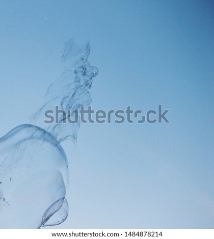 Soap bubbles on a blue sky illuminated by the sun texture background with copyspace