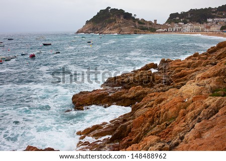 early morning, Rocks and waves of the Mediterranean Sea off the beach in Tossa de Mar, Catalonia, Spain