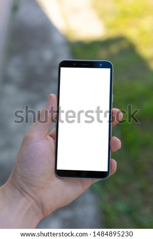 Phone in hand with a white screen, advertising space