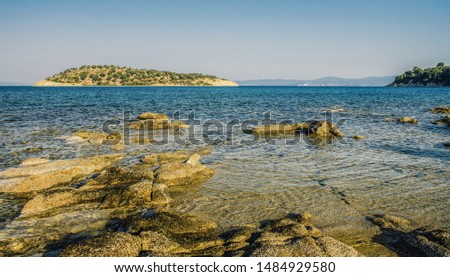 peaceful scenery landscape sea stone coast line picture with island background view on horizon 
