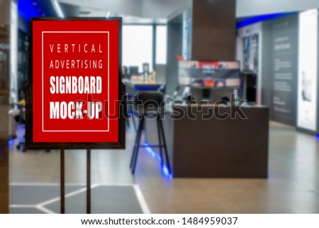 Mock up vertical blank signboard with clipping path in black frame at the showroom, empty space for information and advertising