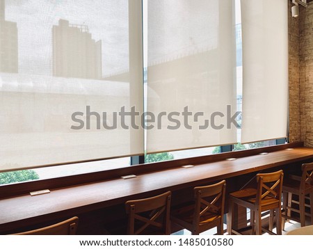 Modern blinds traditional home decoration. Sunlight coming through blinds by the window. Curtain at a window overlooking the highest Building of downtown outside. Royalty-Free Stock Photo #1485010580