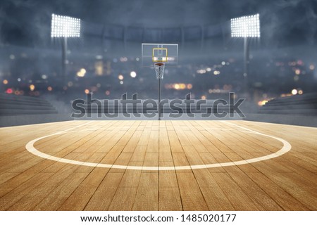 Basketball court with wooden floor, lights reflectors, and tribune over blurred lights background