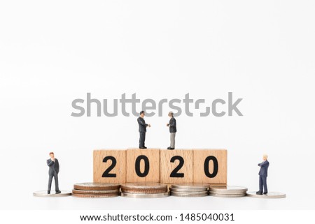 Miniature people : Business people standing on wooden block number 2020  , Happy new year concept