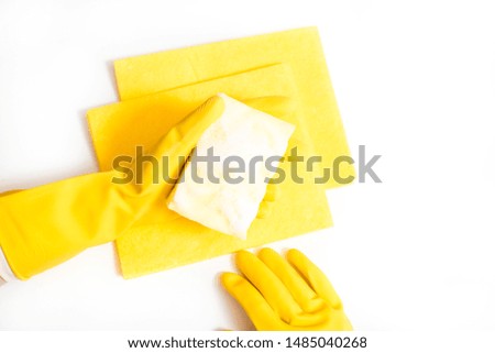 Cleaning the house and sanitation topic: Hand holding a yellow sponge wet with foam isolated on a white background in studio.