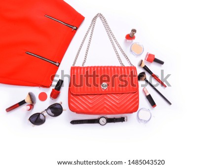 Top view of Female red leather bag, red shoes ,sunglasses, watch and cosmetic


