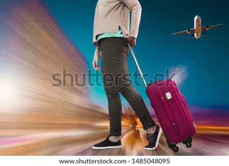 Girl walking with suitcase on wheels before boarding to plane