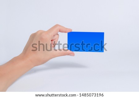 Female hand hold a blue tablet, business card, box on a white background.