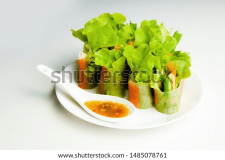 ็Home made salad roll with sour dressing. Organic vegetable and crab stick roll with rice flour.