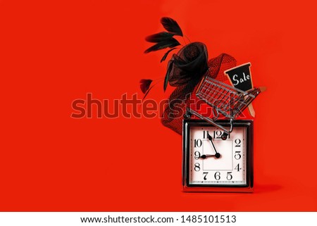 Black Friday sale concept with silver clock, shopping cart with sign sale and female hat retro style on red background. Time planning, copy space. Party concept. Thanksgiving Christmas vintage layout.