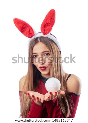 Beautiful girl with rabbit accessory posing on white background. Celebration.