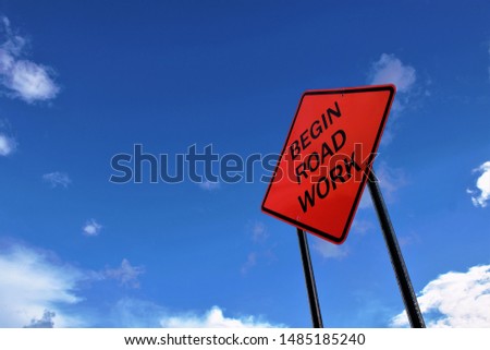 Begin road work sign with blue sky and clouds Royalty-Free Stock Photo #1485185240