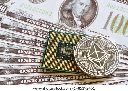 Silver Ethereum with CPU Processor Chip on hundred dollars bills. Close-up, macro shot.