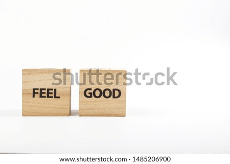 Wooden cubes with the inscription feel good on a white background close up