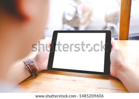 Close up of man using blank tablet sending massages shopping online or reporting lost card, fraudulent transaction in the coffee shop.