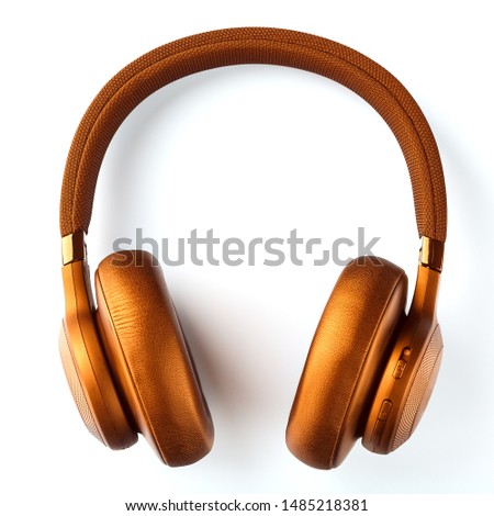 Wireless golden headphones on a white background. View from above. In-ear headphones for playing games and listening to music tracks. Royalty-Free Stock Photo #1485218381