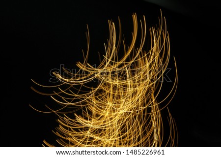 bright stripes of light moving on the black background in motion blur
