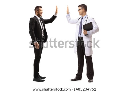 Full length shot of a male doctor making high-five gesture with a man in a suit isolated on white background