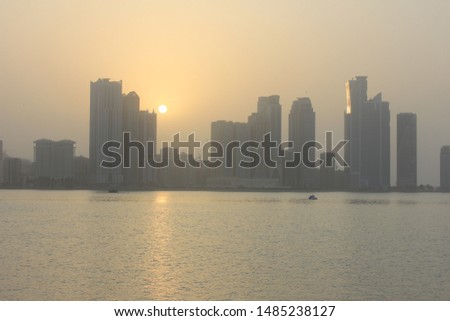 A beautiful Arabian sunset casts a warm golden glow over the man-made Khaled Lagoon in Sharjah, one of seven emirates that constitute the United Arab Emirates (UAE). The lagoon's depth is 4.5 meters.