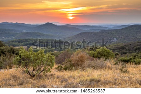 Orange Sunrise over hills of Cevennes national park near Monoblet, Occitanie, Southern France Royalty-Free Stock Photo #1485263537