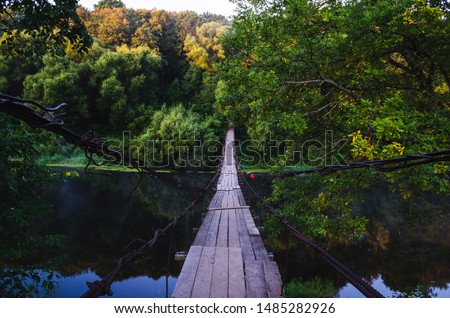 Suspension bridge over the river. Wooden suspension bridge in the summer in the village of Khotylevo, Bryansk Royalty-Free Stock Photo #1485282926