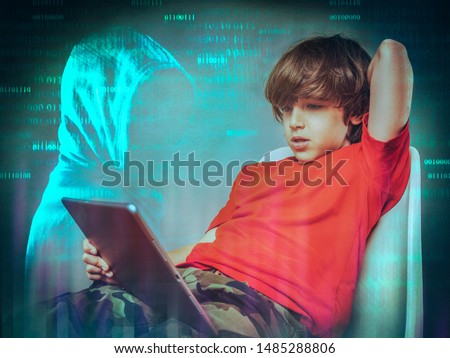  online safety concept   young boy surfing the web  and hooded hacker  Royalty-Free Stock Photo #1485288806