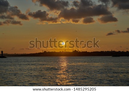 Beautiful sunset in Istanbul, Turkey. Sun is above silhouettes of Hagia Sophia and Blue Mosque. Sunset landscape panorama of Istanbul taken in July, in summer.