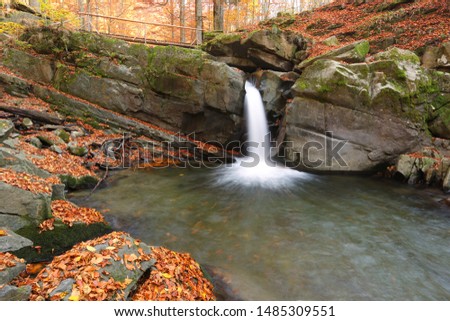 splendid nature mountains image, waterfall in autumn morning forest, water stream between stones and gold leaves, spectacular natural dawn landscape, Europe, Carpathians, Ukraine