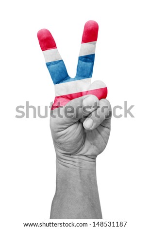 A hand painted with a Thailand flag making a V for victory symbol, isolated against white. 