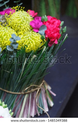 Close up bright bouquet of seasonal flowers, chrysanthemum, tulip, eucalyptus, carnation, selective focus