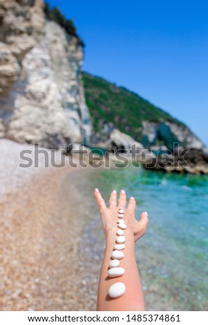 Pebbles on the hand on background. Handful of sea stones. Conceptual design