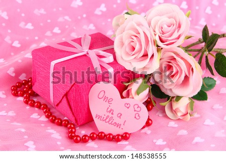 Romantic parcel on pink cloth background