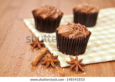 Lovely fresh chocolate cupcake on green cloth. Very shallow depth of field 