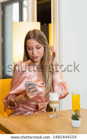 Attractive young  woman looking in the cell phone