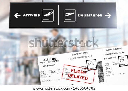 boarding pass with airline flight delayed stamp on air travel ticket against blurred airport interior background flat view of departures arrivals sign and document with dummy lettering and code