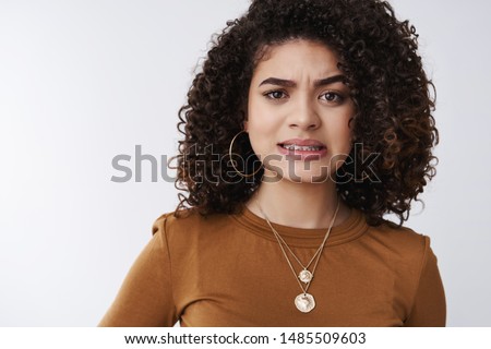 Yikes that hurts. Cute worried girl cringing clench teeth awkward frowning displeased feel empathy friend bumped toe painfully standing upset nervous white background grimacing dislike Royalty-Free Stock Photo #1485509603