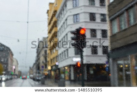 Torrential rain. Rainy evening in the city. Drive. Poor weather conditions. Red traffic light. Overcast. Shower. Bad visibility on roads. Perspective. Blurred avenue scene. Flow. Blur urban background