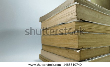 Tekstru stack of old books on a white background - image
