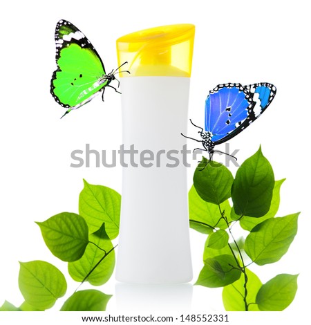 Plastic bottle and butterfly on green leaves background