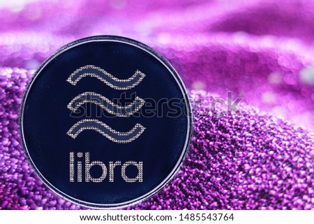 Token cryptocurrency libra  and neon fabric background.