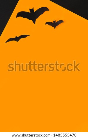 The concept for Halloween. Bats on an orange background.
