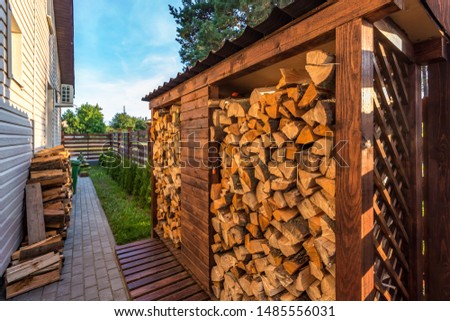 harvesting firewood for the winter near wooden village vacation home