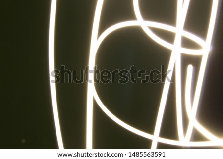 Abstract colorful irregular lines on black / green background photo with long exposure . Light painting photography. Lights with irregular patterns for overlay 