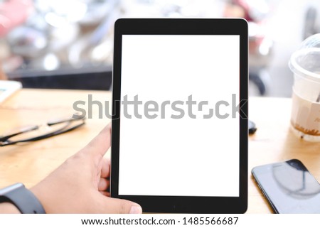 Close up of man using blank tablet sending massages shopping online in the coffee shop.