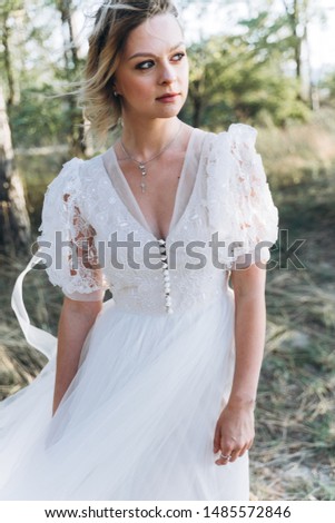 Girl in a wedding dress on the sand