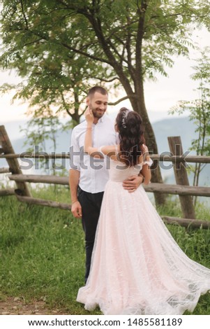 Lovestory of beautiful couple in the mountains, Handsome bearded man with beautiful and charming woman